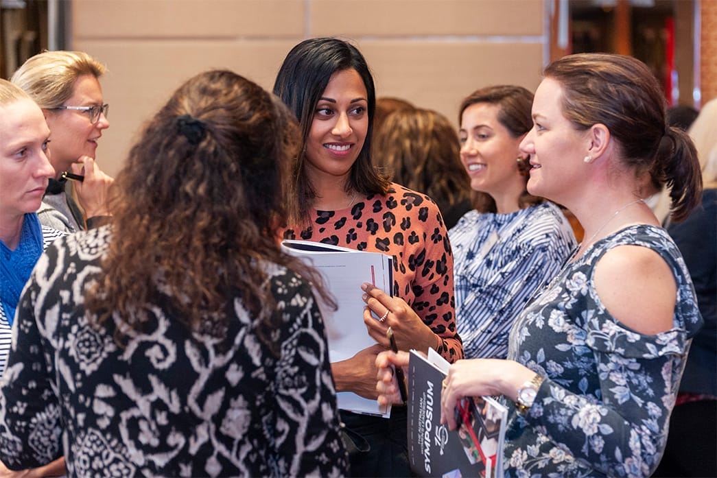 Women talking at the Symposium
