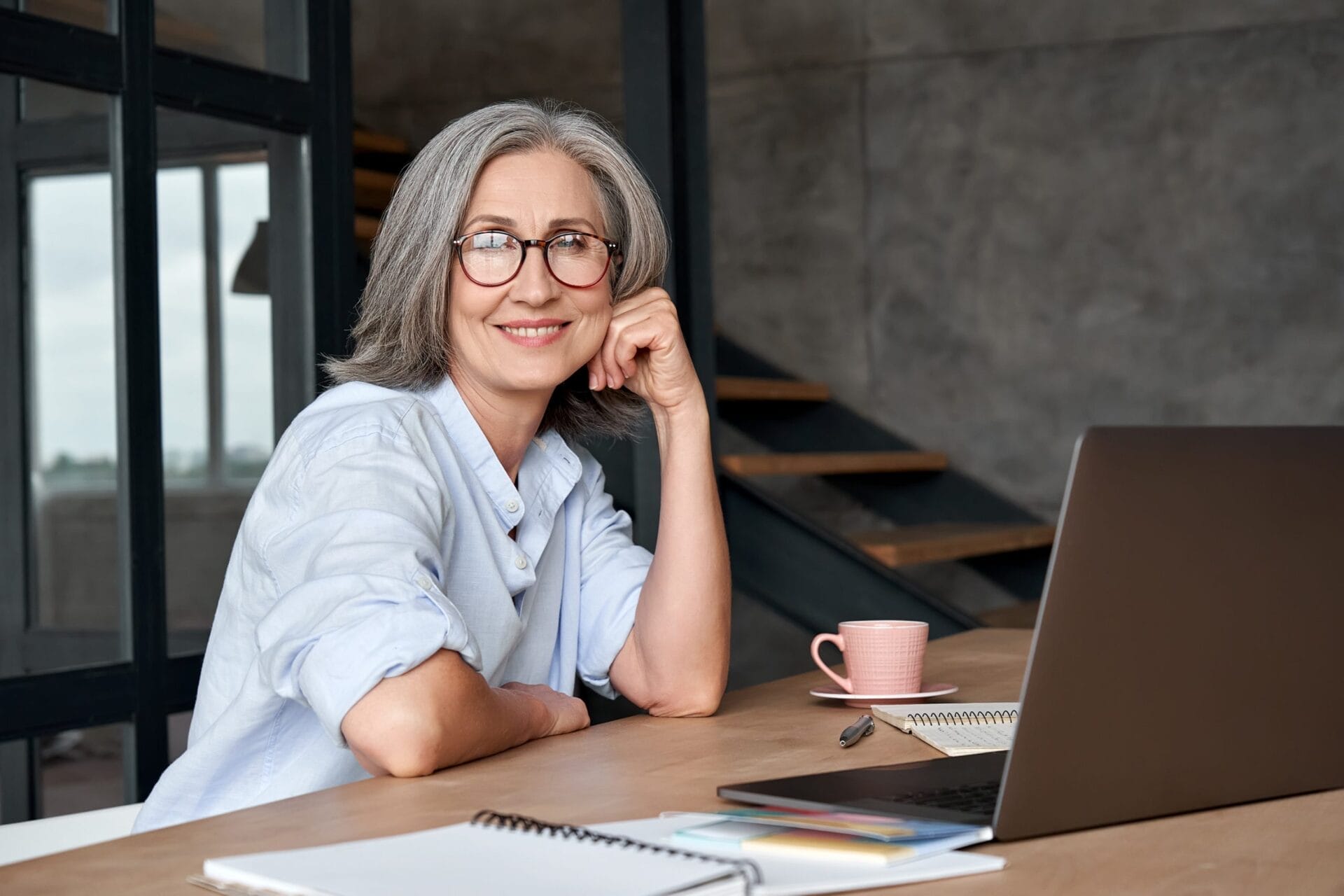 Professional looking elderly lady working on a laptop