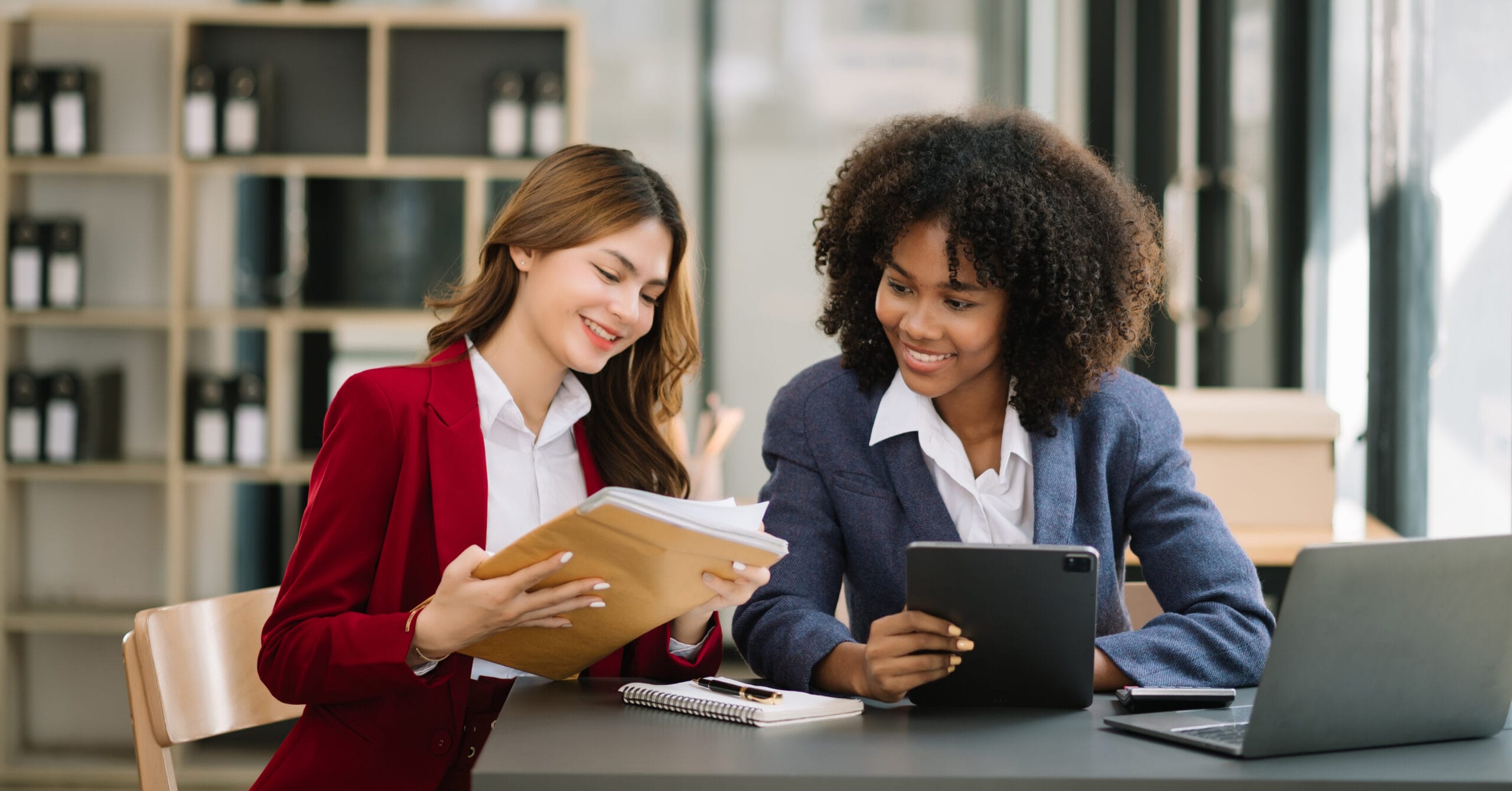 Two businesswoman discuss investment project working and planning