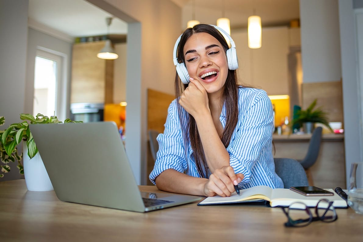 Woman on her laptop attending an online Symposium