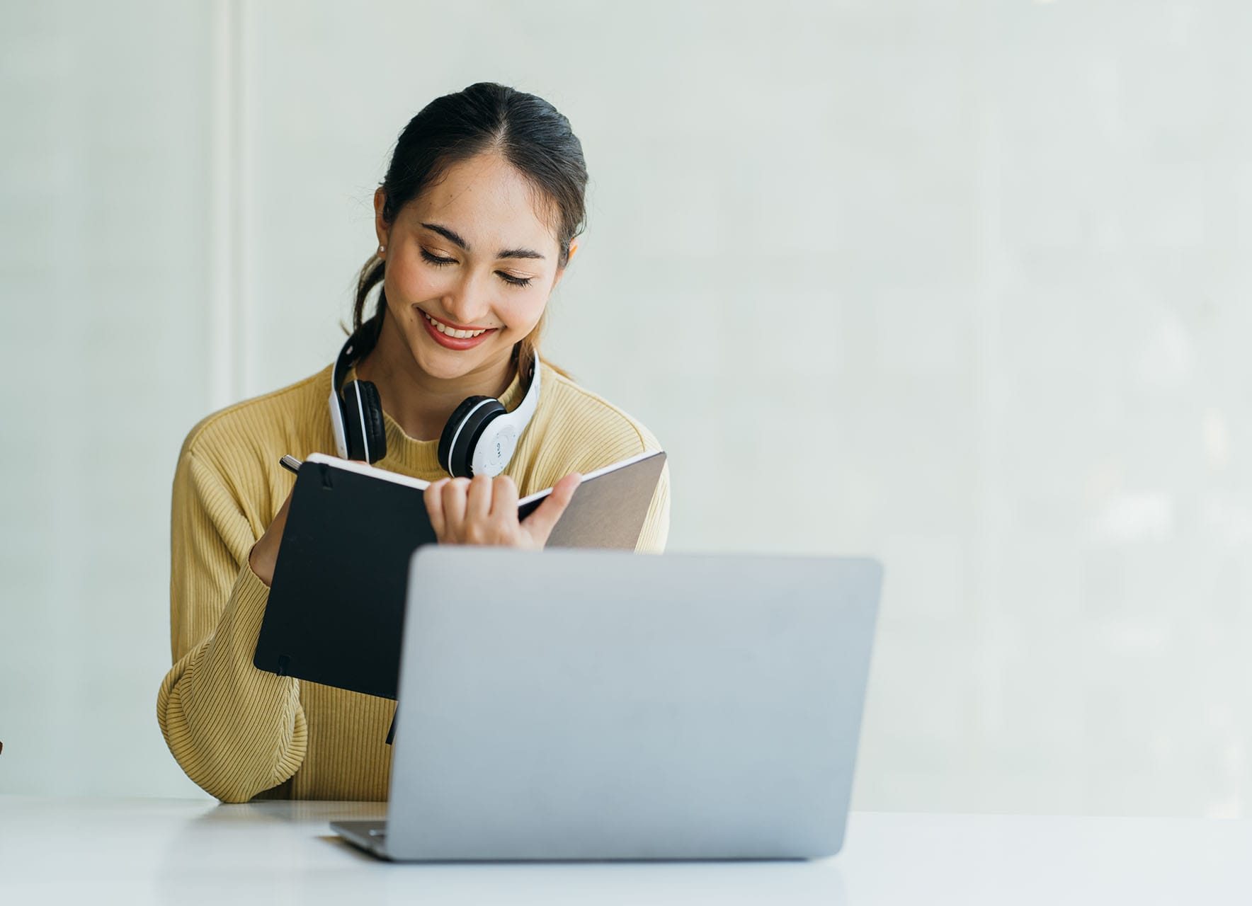 Smiling woman looking at laptop scree