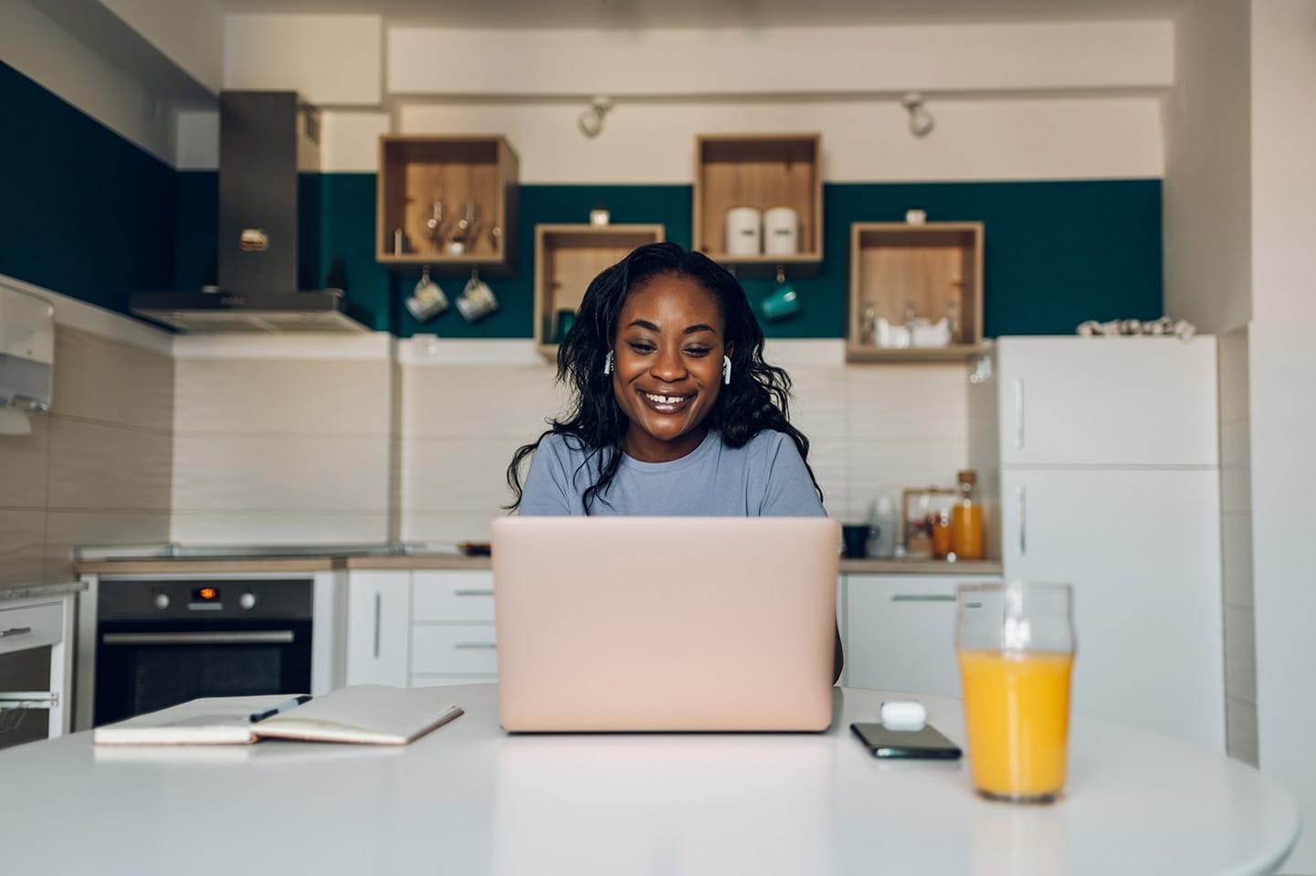 Woman at computer in kitchen