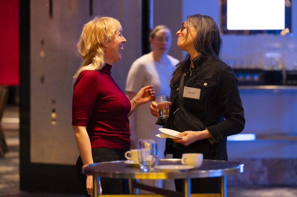 Two women talking in a networking event