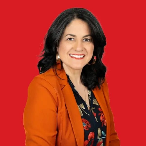 A headshot of Fabiola Campbell in a red background