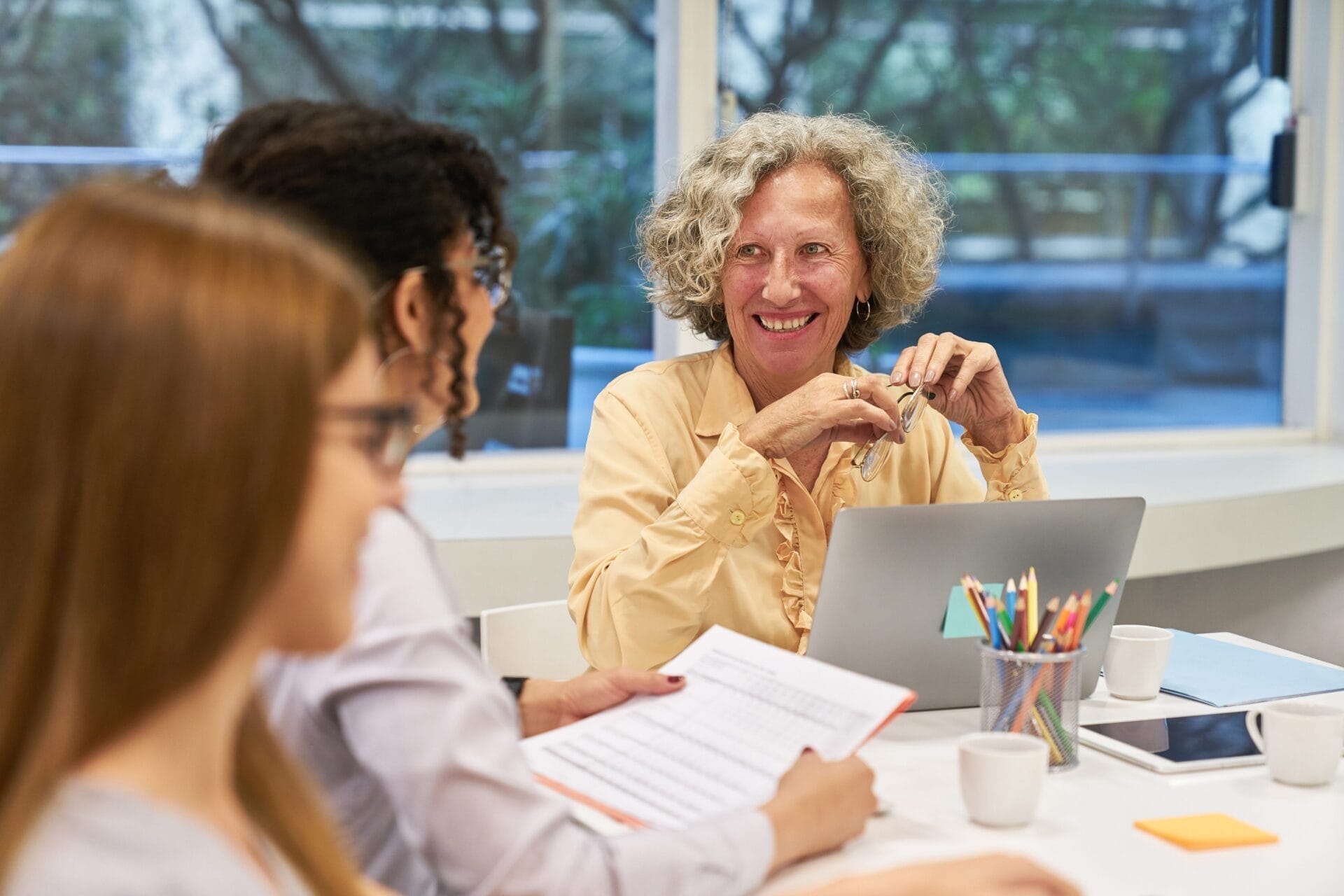 woman in meeting looking at colleagues