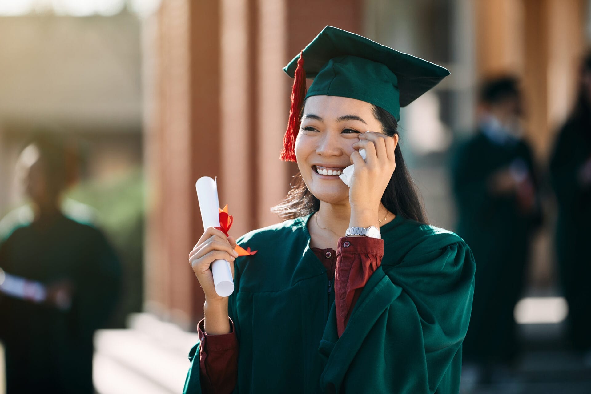 woman graduate happy tears holding degree