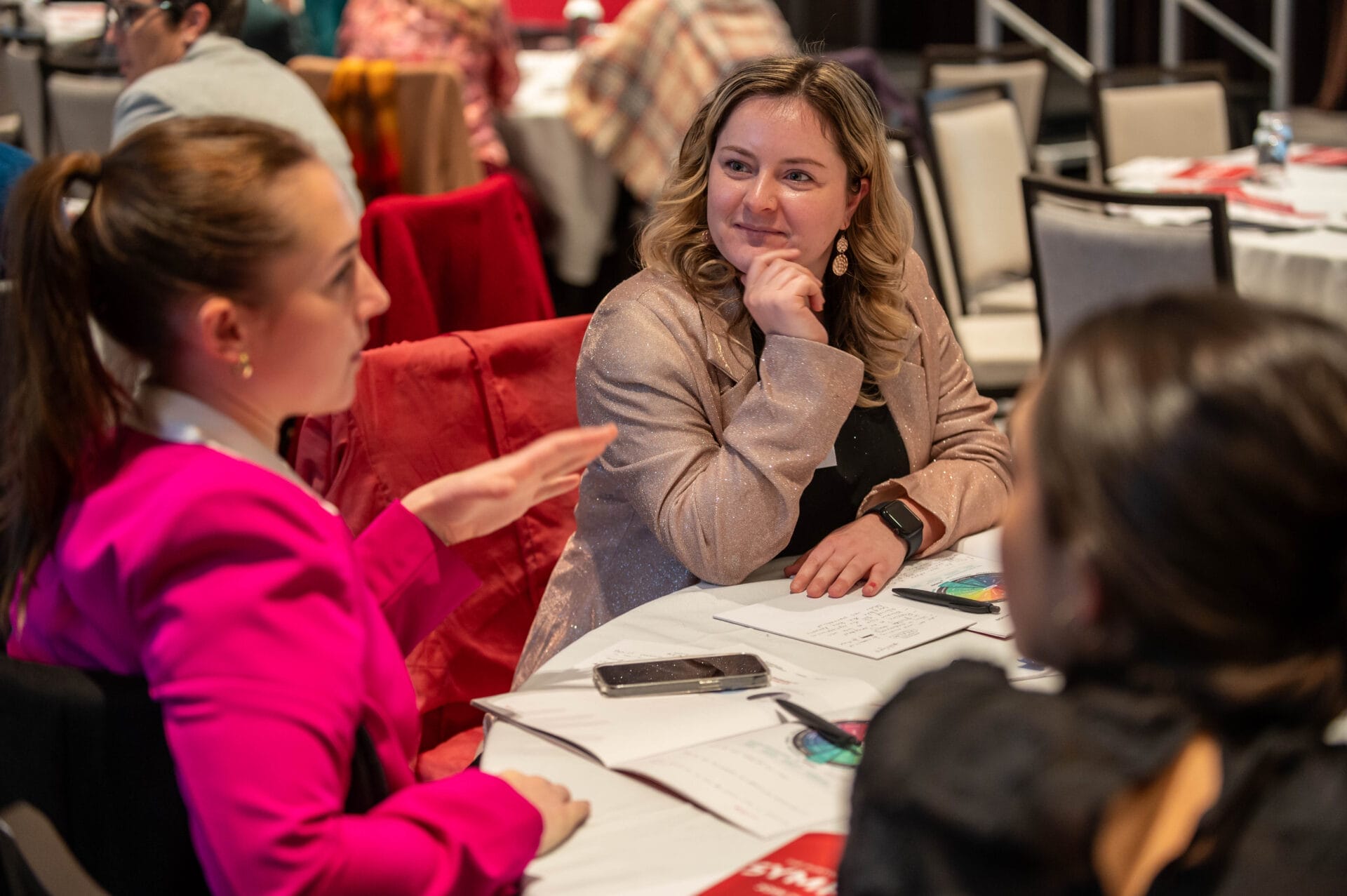 Two women discussing the wheel of privilege during the development session at the Symposium