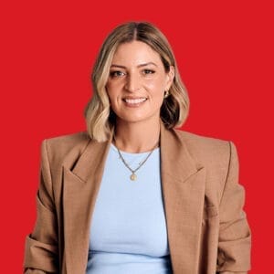A headshot of Angela Davies in a red background