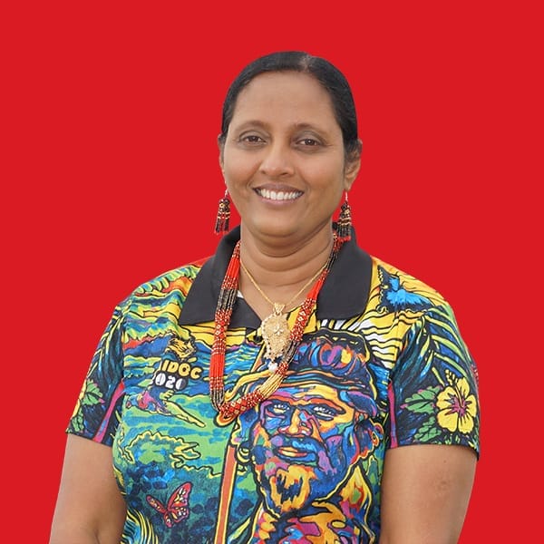 A headshot of Asha Bhat in a red background