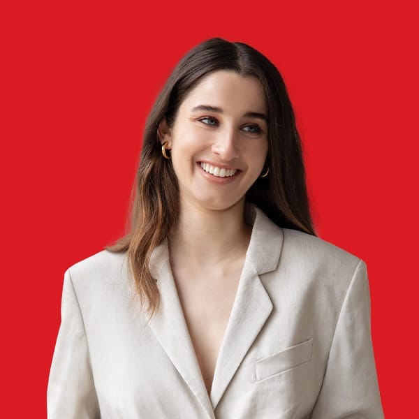 A headshot of Chanel Contos in a red background