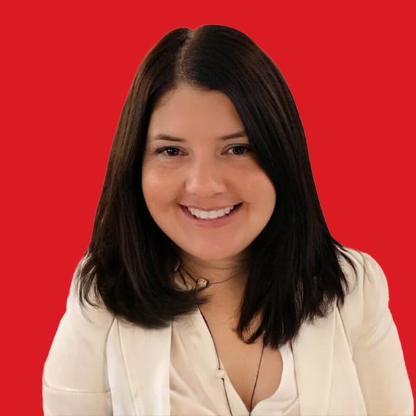 A headshot of Tricia Spargo in a red background