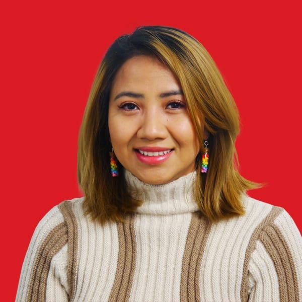 A headshot of Vy Pham in a red background