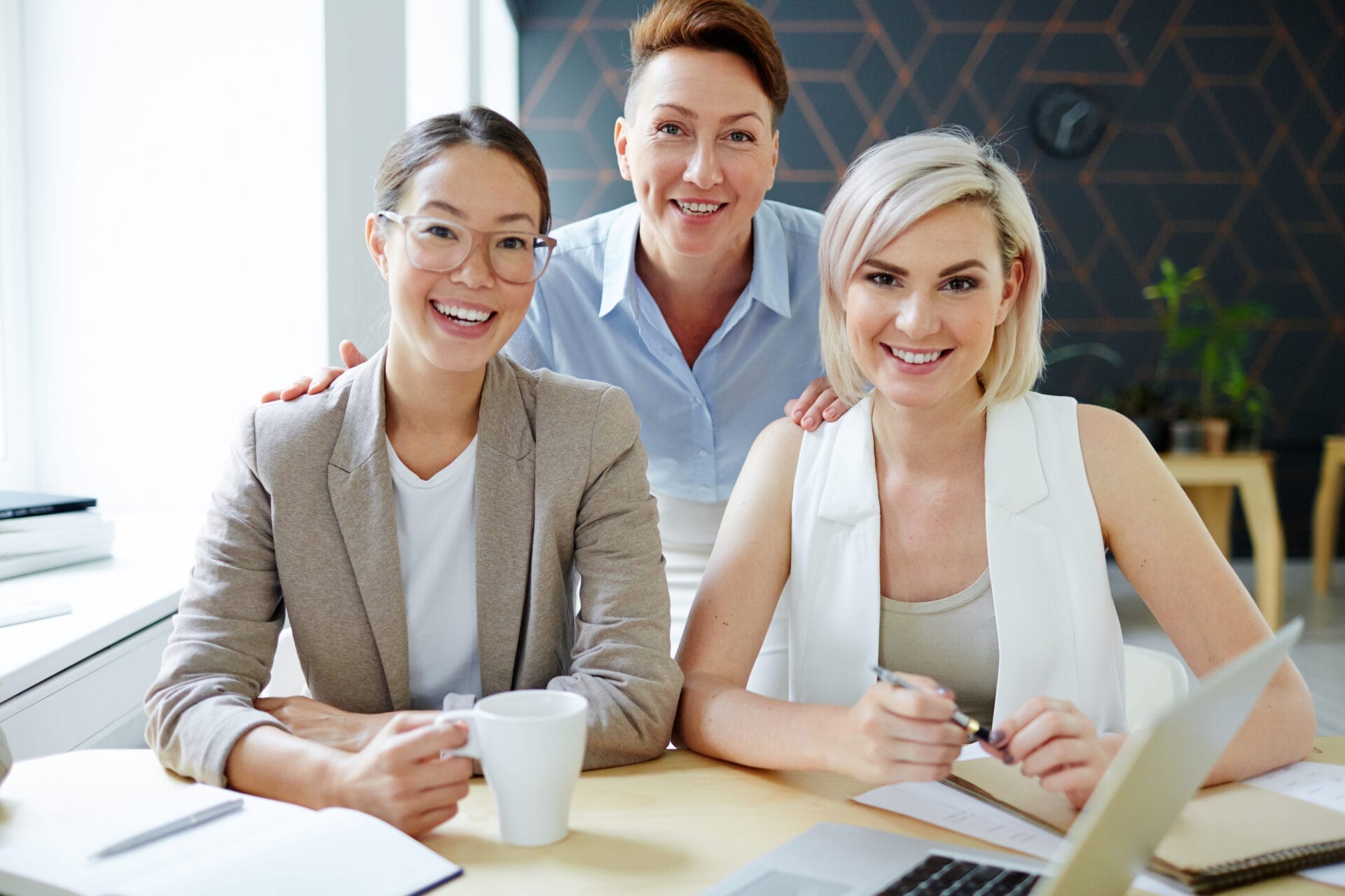 Friendly colleagues smiling at work