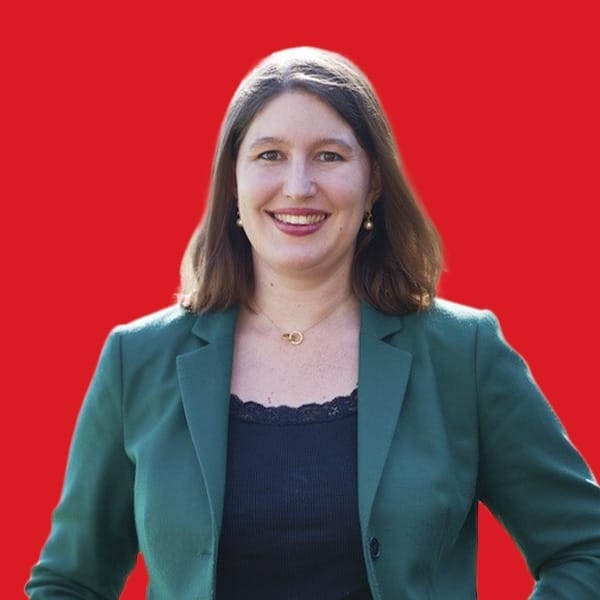 A headshot of Lorraine Finlay in a red background