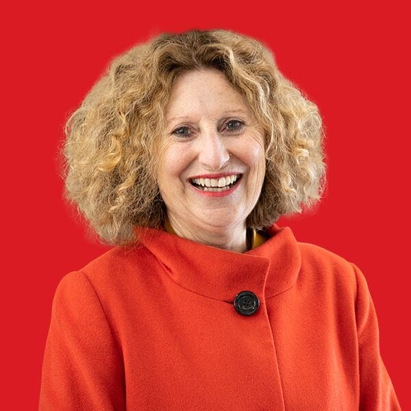 A headshot of Monica Barone in a red background