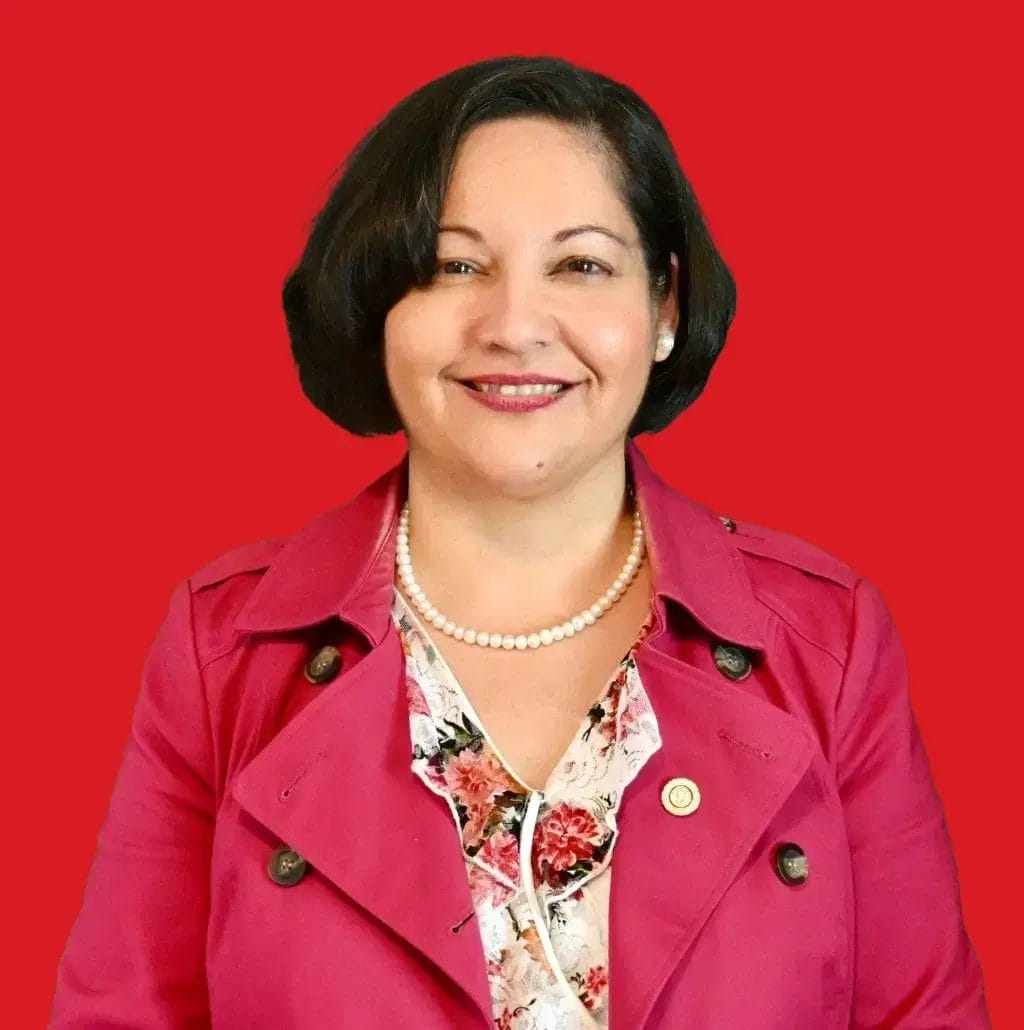A headshot of Pallavi Sinha in a red background