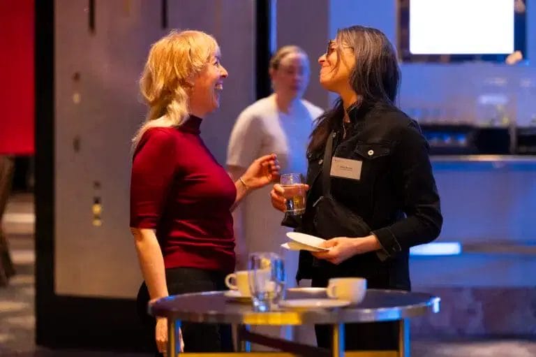 Two women talking in a networking event