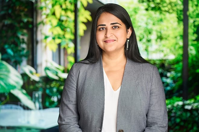 Dr Manasi Murthy Mittinty profile photo. She wears a grey suit jacket and is smiling