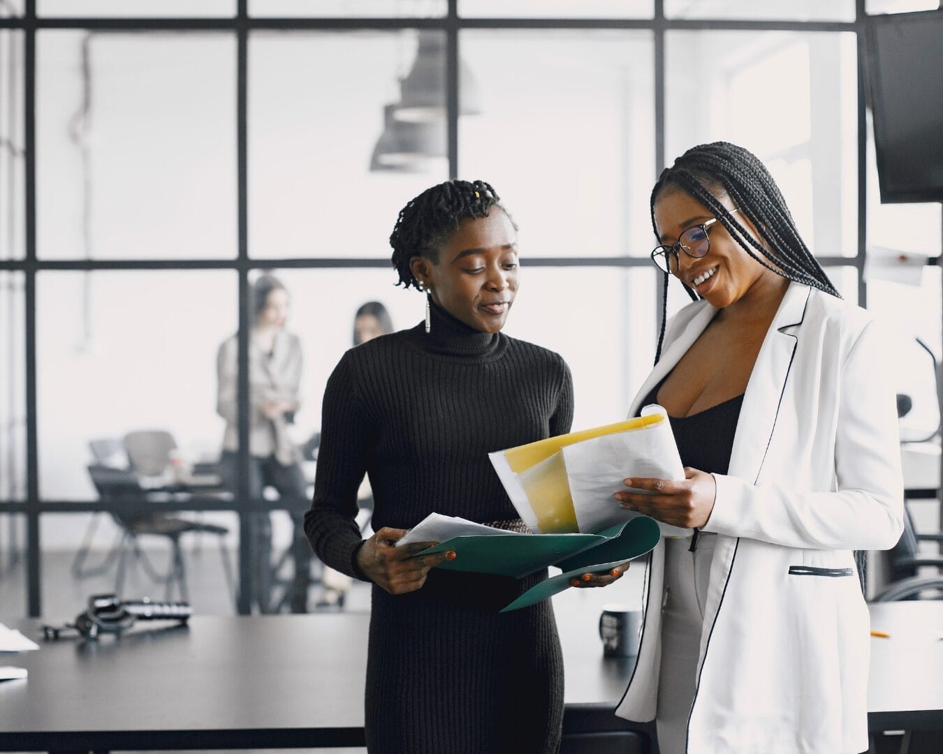 Two women looking at work documents together