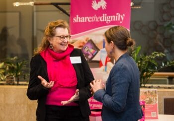 Two participants having a conversation at the Brisbane Symposium